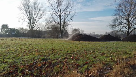 MOERS / GERMANY - JANUARY 18 2019 : Pile of manure steaming in the field.