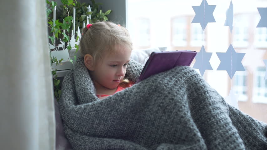Little Girl Wrapped Plaid Using Tablet PC