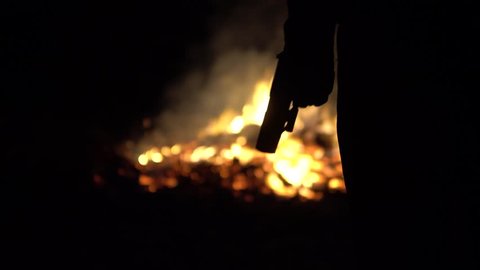Cinematic Silhouette Of Gun In Front Of Burning Body Or After Explosion Scene.