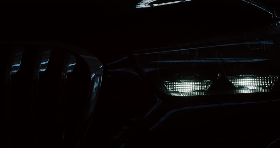 Close up of details of switched on headlights of anonymous prestigious luxury modern car. Shot in 8K. Concept of passion for driving cars and engines, car dealerships, used cars,luxury cars, auto dial Royalty-Free Stock Footage #1022657104
