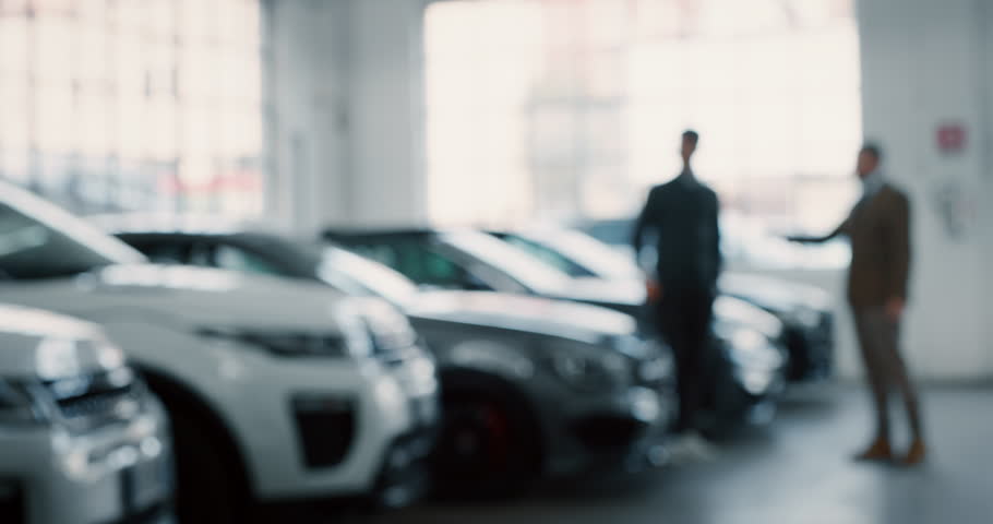 Dealer and new owner handshake after concluding a car deal in auto show or salon. Slow motion shot in 8K. Concept of car dealerships, used cars, car sale and rent, auto deal. Royalty-Free Stock Footage #1022658490