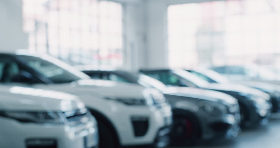 Close up of dealer giving key to new owner in auto show or salon. Slow motion shot in 8K. Concept of car dealerships, used cars, car sale and rent, auto deal Royalty-Free Stock Footage #1022658493