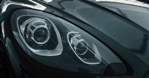 Close up of details of headlights of anonymous prestigious luxury modern car. Shot in 8K. Concept of passion for driving cars and engines, car dealerships, used cars,luxury cars, auto dial
