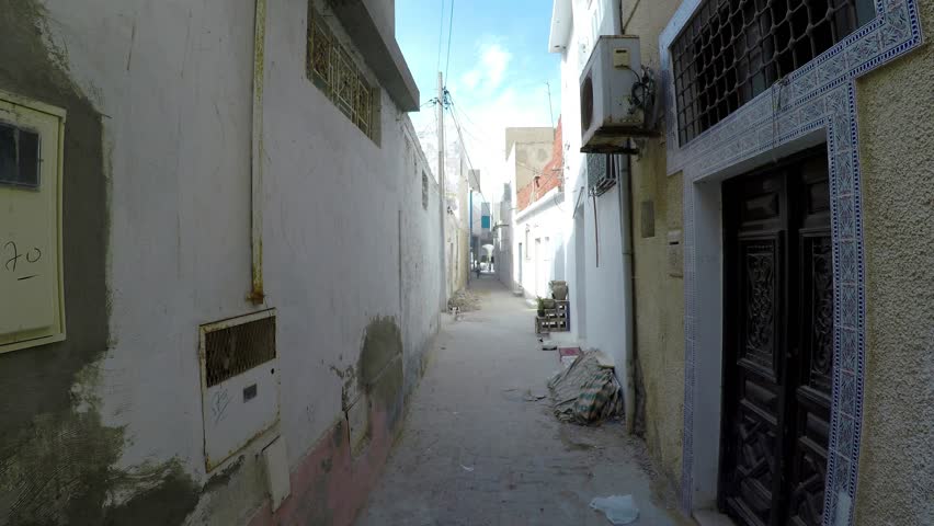 Ancient narrow street in central Monastir. Tunisia. Old town. Architecture, old houses, streets and neighborhoods. Shot in 4K (ultra-high definition (UHD)).