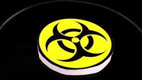 Biohazard sign symbol on rotating plate seamless looping background