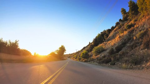 Car travel gopro point of view across mediterranean coastline nature, golden shining sun, asphalt road POV drive