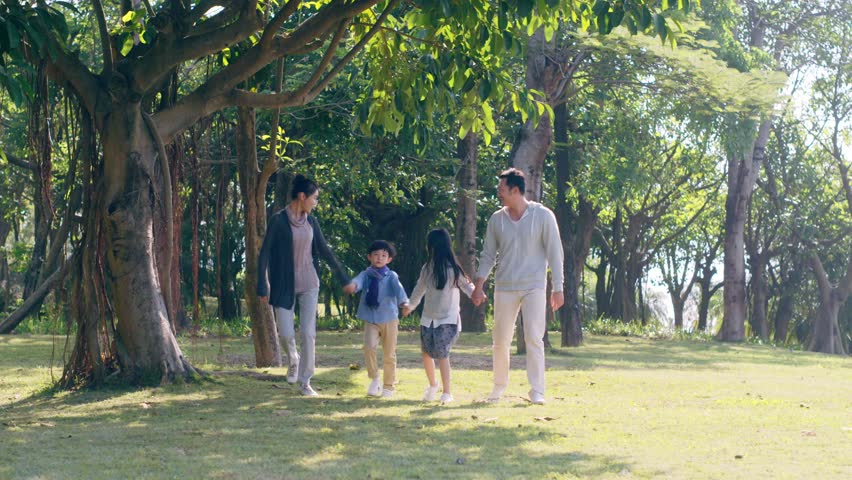 asian family with two children walking hand in hand having fun in park Royalty-Free Stock Footage #1022674516