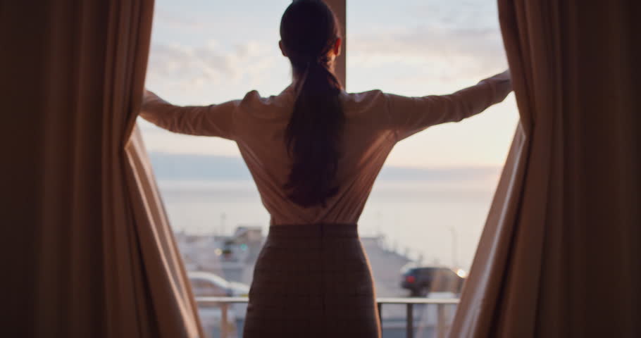 business woman opening curtains in hotel room looking out window fresh new day successful independent female planning ahead at sunrise Royalty-Free Stock Footage #1022682604
