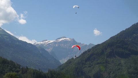 Glider in mountains. Alpine peaks landskape background. Jungfrau, Bernese highland. Alps, tourism, journey concept.