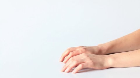 Naked woman's hands applauded on a white background