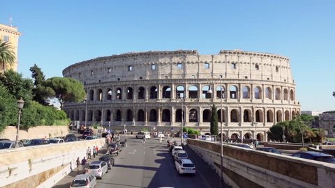 ROME, ITALY - CIRCA May 2018: Panorama of famous attraction Colosseum in Rome, Italy. Veiw from road on ancient Flavius amphitheater Coliseum. Tourists walking and cars passing by
