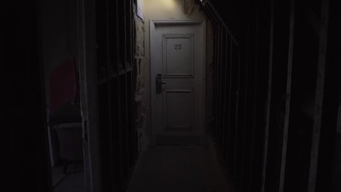 creepy hotel room in dark loft space corridor hallway number 25 door
