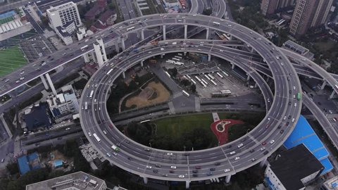 Circular junction at end of Nanpu bridge, aerial orbiting shot. Light traffic at inner ring road of Shanghai. Interesting construction of elevated interchange, large ring with slipways
