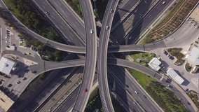 Aerial drone top view time lapse video of highway junction multi level overpass passing through city centre