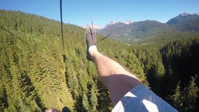 Feet Dangling From Zipline with Blackrock Whistler Mountain in Front in Slow Motion POV