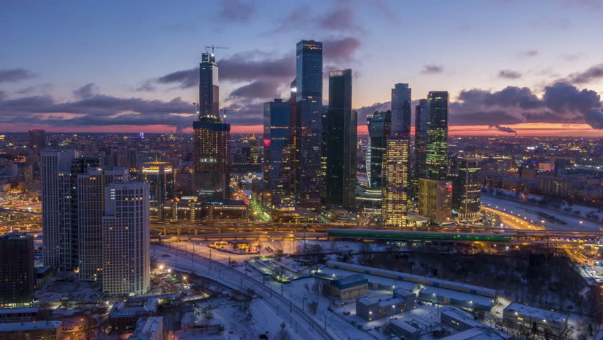 Skyscrapers of Moscow City Business Center and City Skyline in Winter Morning Twilight. Russia. Aerial Hyper Lapse. Drone is Orbiting. Establishing Shot