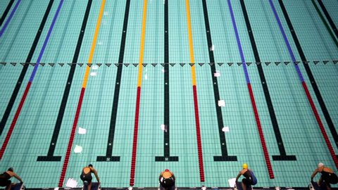 MOSCOW, RUSSIA - APRIL 19, 2015: Sportswomen start to swim breaststroke during Championship of Russia on swimming in Olympic Sports complex.