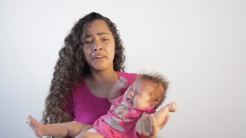 mother shocked by the tantrum of her baby. Desperate with the baby crying a lot. First son