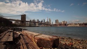 Panoramic Time-lapse with New York City skyline and driftwood as foreground. This video has left to right sliding movement and right to left pan.