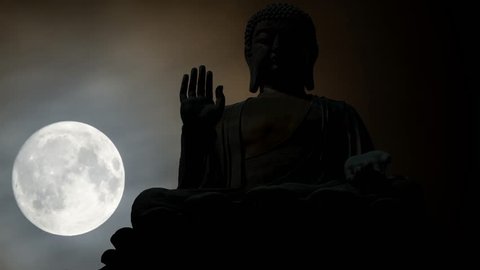 Iconic Statue of Buddah at Night in Time Lapse with Full Moon and Clouds