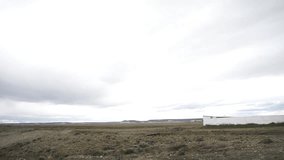 A Man Standing on the Field with His Back to the Camera Saying Goodbye, Waving his Hand to an Airplane Taking Off from the Rio Gallegos International Airport, Santa Cruz, Argentina.