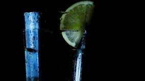 glass of water and lemon on black background - Powered by Shutterstock - Get 15% off with code: PIKWIZARD15