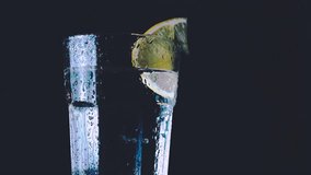 glass of water and lemon on black background - Powered by Shutterstock - Get 15% off with code: PIKWIZARD15