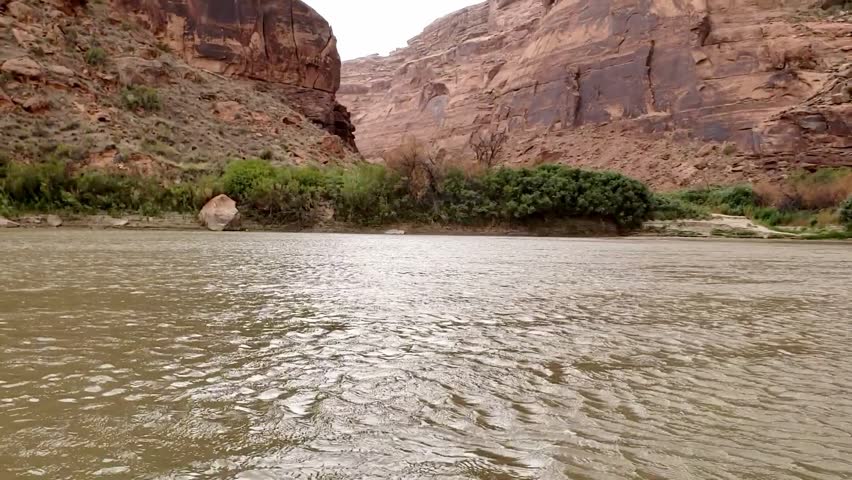 Guys canoeing down river in Utah
