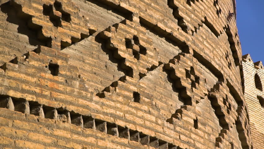 A steady close angle view of the artistic patterns on the walls of a castle