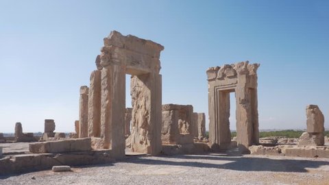 Scenic ruins of the Hadish Palace (the Palace of Xerxes) on blue sky background in Persepolis, Iran. Ancient Persian city. Persepolis is a popular tourist destination of the Middle East.