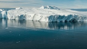 Global Warming and Climate Change - Giant Iceberg from melting glacier in Ilulissat, Greenland. Aerial drone of arctic nature landscape famous for being heavily affected by global warming. Hyperlapse.