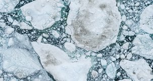 Icebergs drone aerial video top view - Climate Change and Global Warming - Icebergs from melting glacier in icefjord in Ilulissat, Greenland. Arctic nature ice landscape in Unesco World Heritage Site.