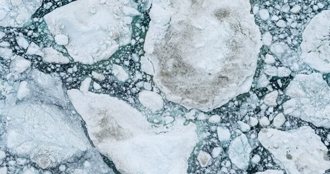 Icebergs drone aerial video top view - Climate Change and Global Warming - Icebergs from melting glacier in icefjord in Ilulissat, Greenland. Arctic nature ice landscape in Unesco World Heritage Site.