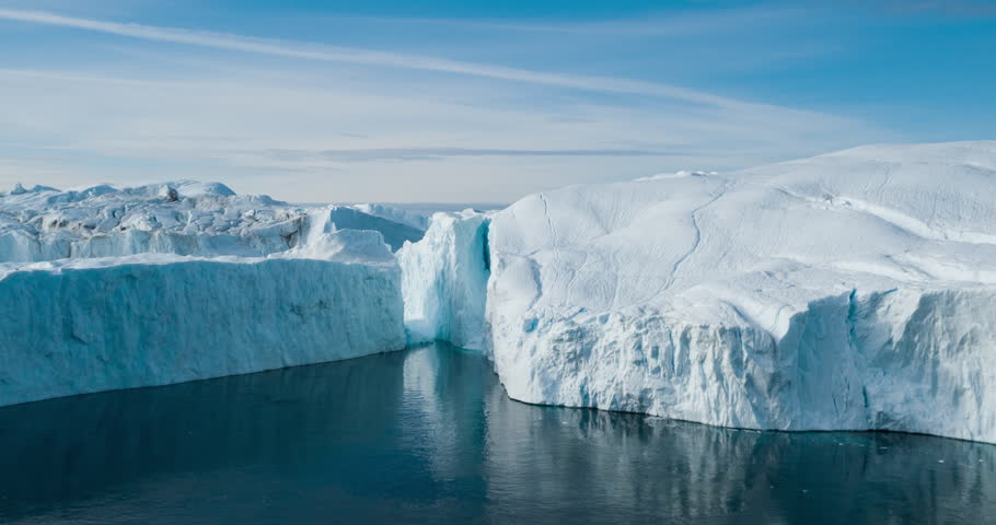Iceberg aerial drone video- giant icebergs in Disko Bay on greenland floating in Ilulissat icefjord from melting glacier Sermeq Kujalleq Glacier Affected by Global warming and climate change. Royalty-Free Stock Footage #1022793019