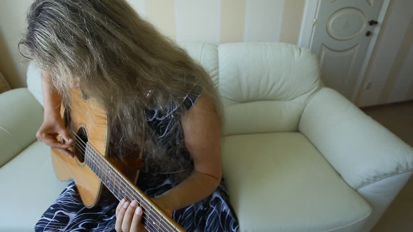 Young beautiful woman in bright outfit enjoying the music at home