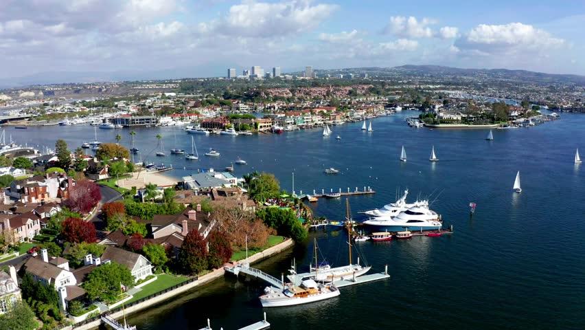 Aerial view of sunny Newport Beach Harbor with sail boats
