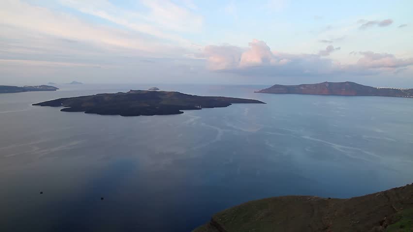 Santorini, Greece. Oia town on Santorini island, Greece. Traditional and famous cycladic houses and churches with blue domes over the Caldera, Aegean sea and beautiful nature. Oia village, Fira