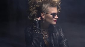 Beautiful blonde rocker girl in leather jacket and sunglasses, posing in the smoke - Powered by Shutterstock - Get 15% off with code: PIKWIZARD15