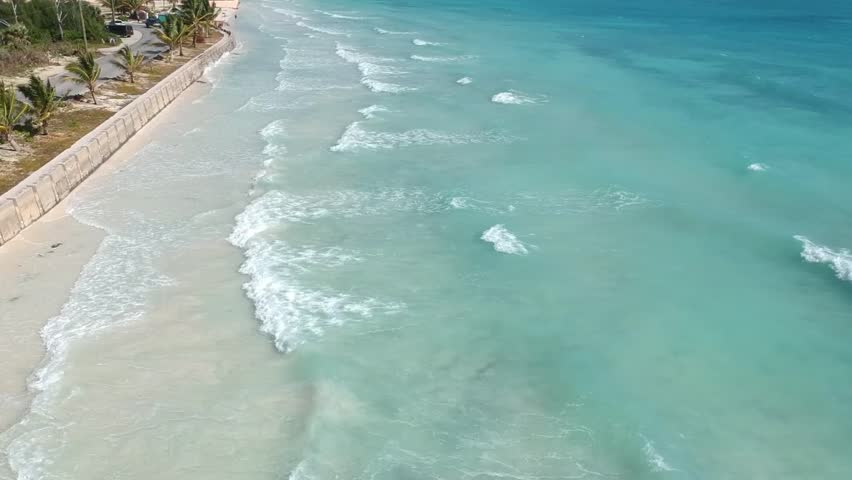 Tropical shoreline view at William’s Town Beach and Island Seas Resort in Freeport, Grand Bahama Island, featuring pristine white sand and calm turquoise Caribbean waters.