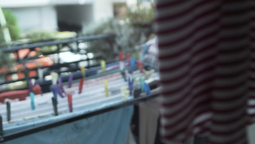 Family laundry drying on balcony. Rack focus. | Shutterstock HD Video #1022818477
