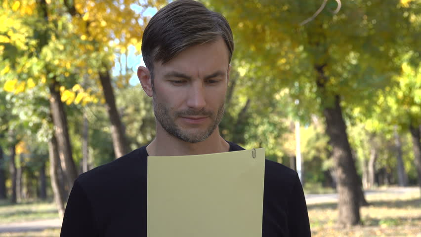 MAN VIEWS THE PAPER TEXTS. THE BREAD MAN READS A DOCUMENT. AGE OF FORTY YEARS.