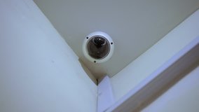 surveillance camera inside the office, at home. watching people. camera on the wall. human face detection technology. security at home, office, enterprise. Big brother is watching you. criminal area.
