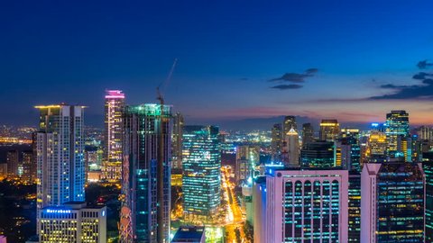 METRO MANILA, PHILIPPINES - CIRCA MARCH 2018: Time-lapse view on the illuminated skyline of Makati at night circa March 2018 in Metro Manila, Philippines.
