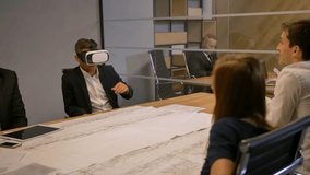 Employee and his colleagues working with VR Future technology concept and drawing. Discussion about engineering solutions of construction in modern glass office. 4k Slow motion - Powered by Shutterstock - Get 15% off with code: PIKWIZARD15