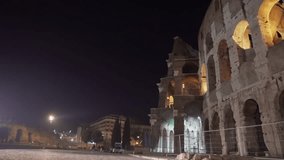 Ancient ruin facade of Colosseum at night in Rome Italy. Closeup. 4K.