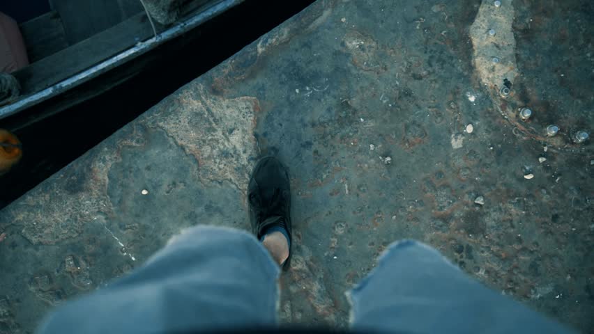 Walking and stepping on to a small boat in Lamu Kenya