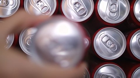 Female Hand Taking Sweet Drink or Beer in Aluminium Can from a Pack in Supermarket Shop. 4K Slowmotion Consumerism Concept Footage.