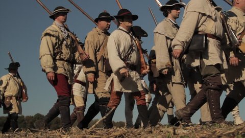 VIRGINIA - OCTOBER 2018 - Reenactment, large-scale, epic American Revolutionary War anniversary recreation -- Continental Army Soldiers in formation marching as on parade with Musket &, flags.