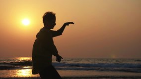 Silhouette of active senior woman practicing tai chi gymnastic on sandy beach at sunset in slow motion - Powered by Shutterstock - Get 15% off with code: PIKWIZARD15