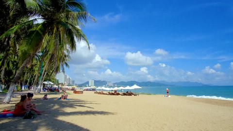 Nha Trang city, Vietnam -11 2018:  Panoramic view sand beach. Crowd people travel, tourists relax on the coastline. Nha Trang is the most popular destinations in Vietnam. Summer holiday vacation backg